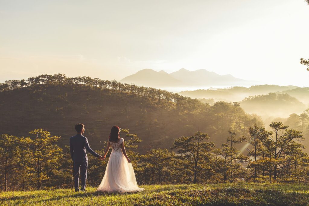 Bride and groom standing in a field